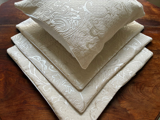 Pile of Cream Brocade Cushion Covers by Curlew Crafts. One is shown full