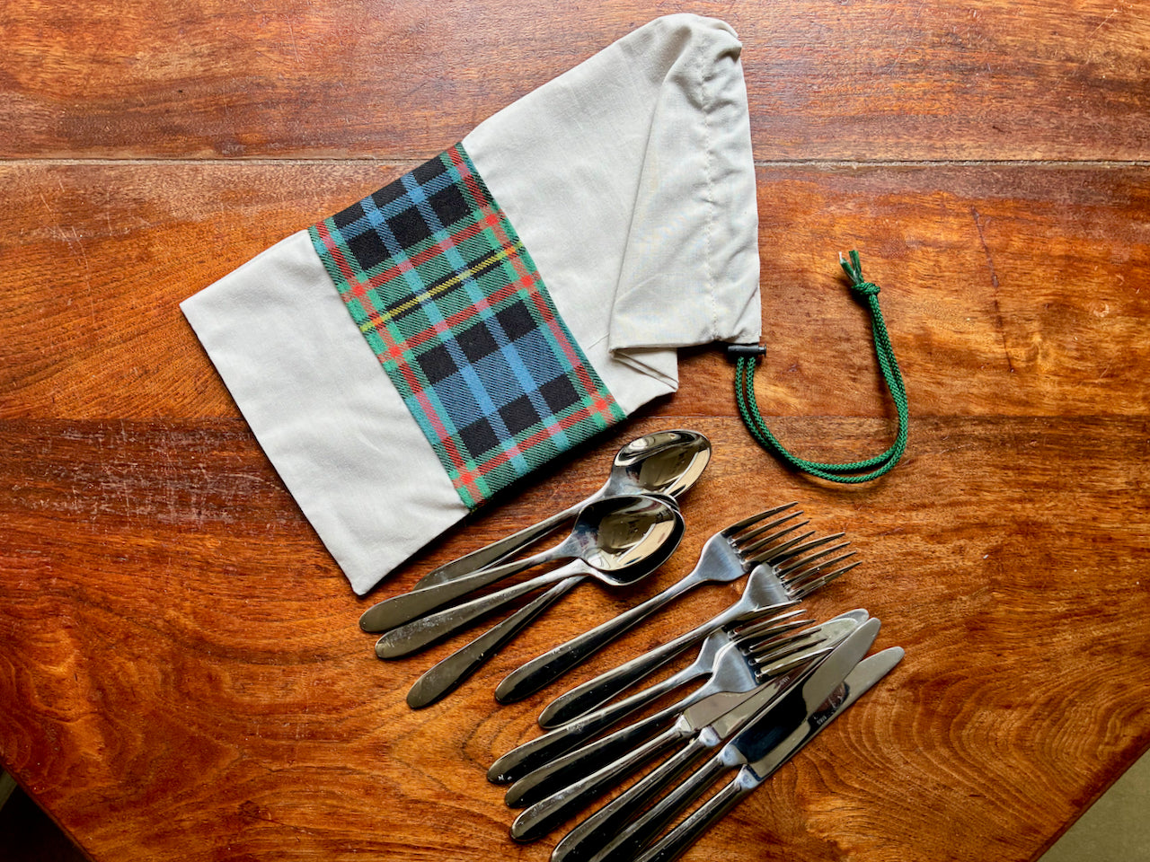 Set of silverware beside a Tartan Drawstring Bag  by Curlew Crafts