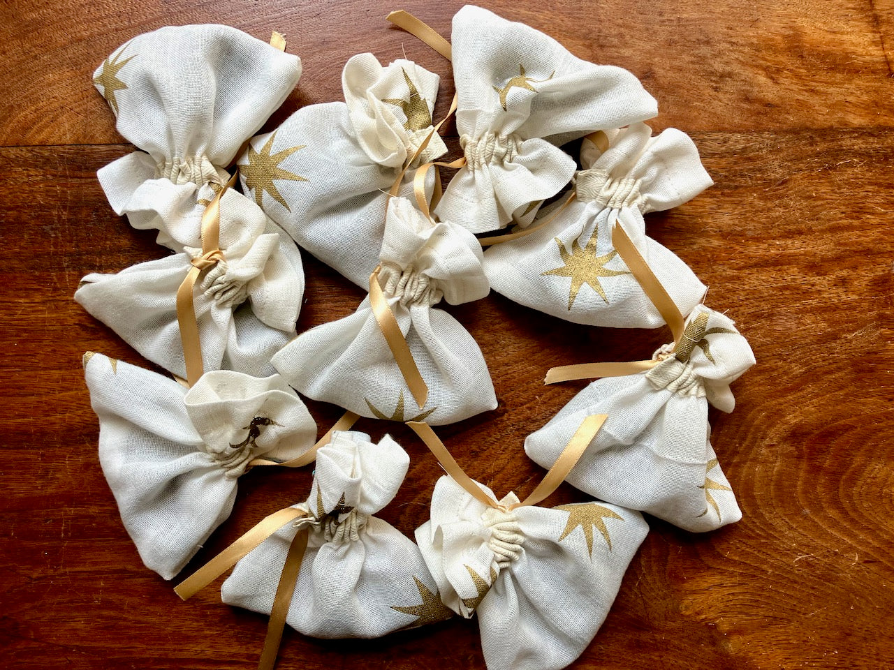 Pile of White starry cotton Lavender Bags with Gold drawstrings by Curlew Crafts