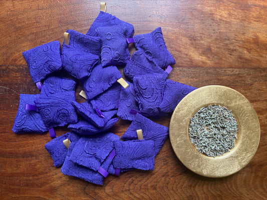 Small Purple Lavender bags with Satin hooks by Curlew Crafts beside a Gold saucer of dried Lavender