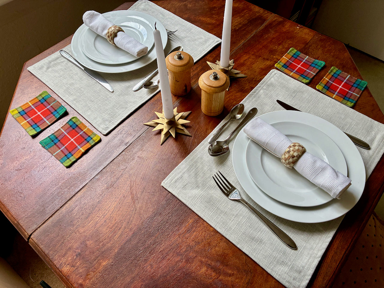 Table set with Tartan Coasters by Curlew Crafts, place mats, plates, cutlery, napkins and decorative items