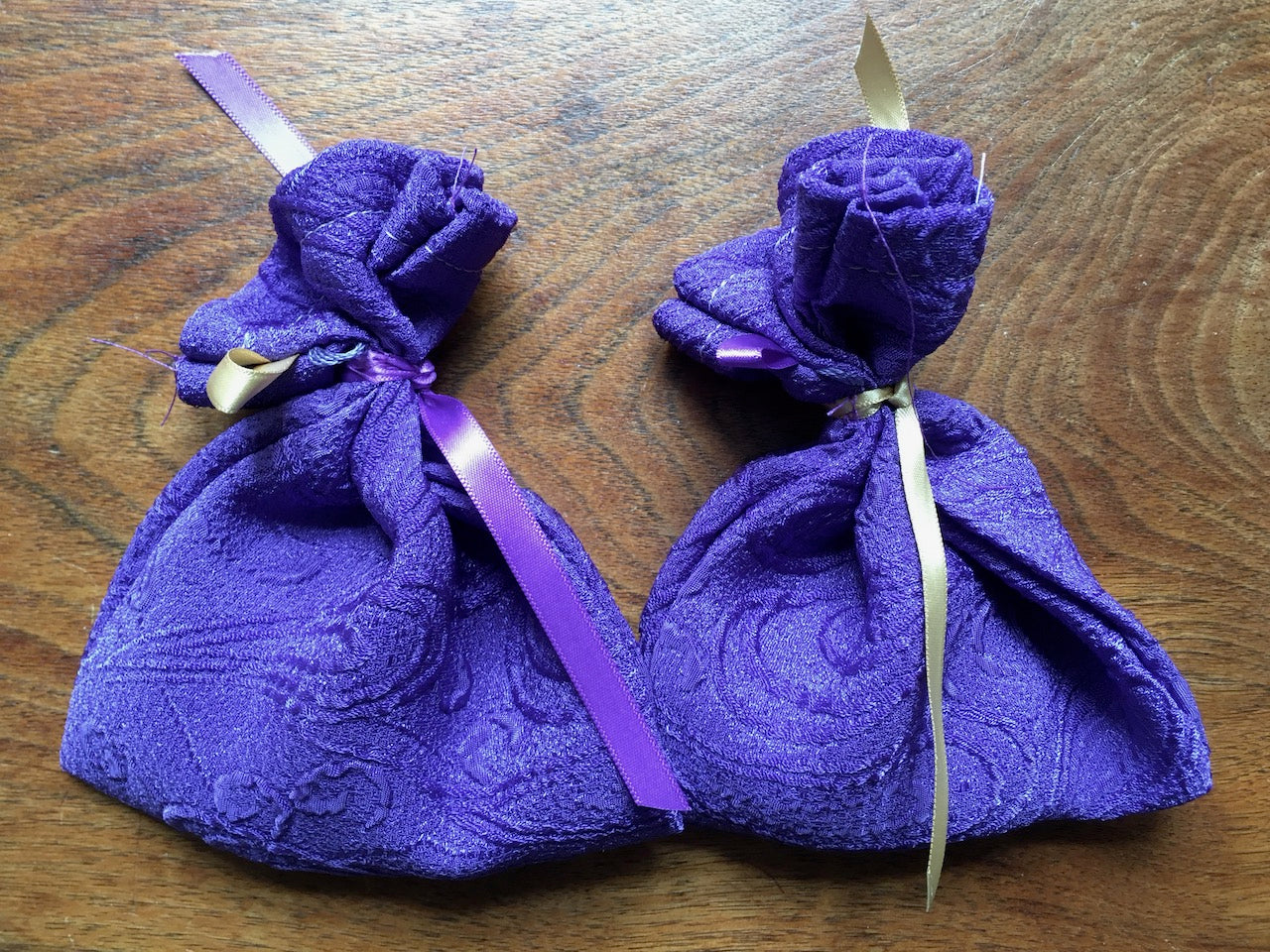 Two purple Lavender bags tied with gold and purple ribbons by Curlew Crafts