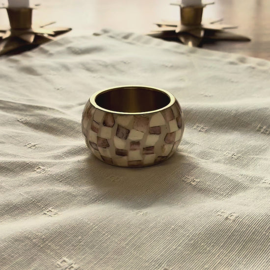 Cream Brocade Napkin by Curlew Crafts being placed in a Napkin Ring